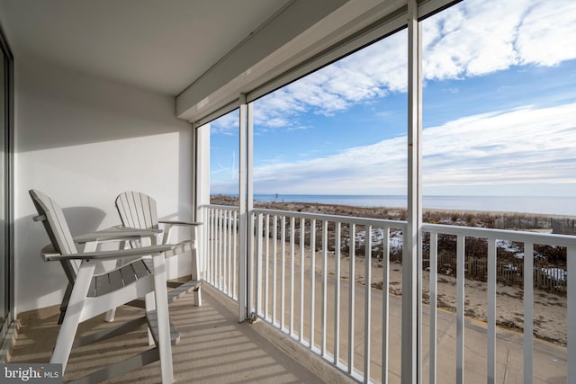 exterior space with a water view and a view of the beach