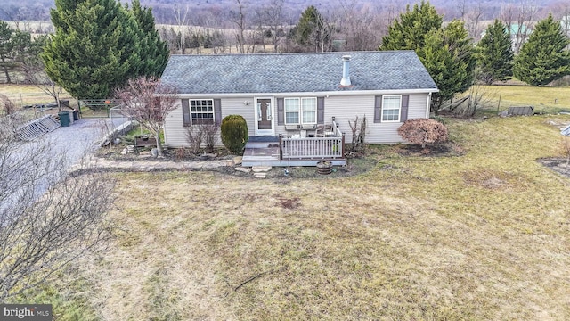 view of front of house with a front yard and a deck