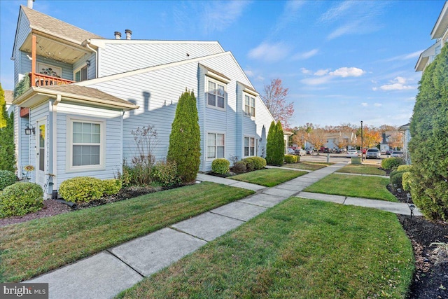 view of home's exterior with a yard