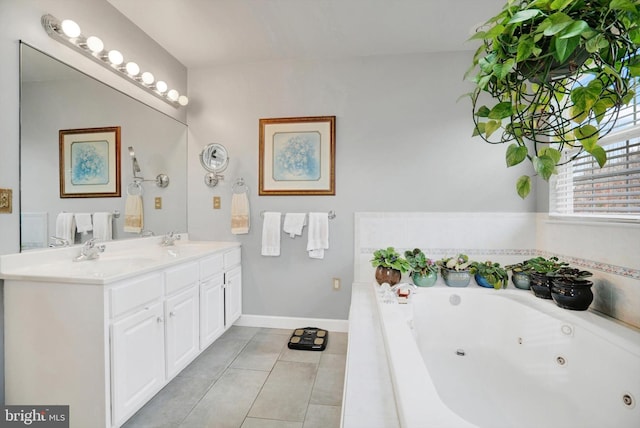 bathroom with tile patterned floors, tiled tub, and vanity