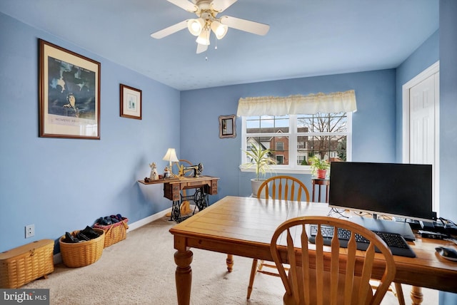 carpeted office space with ceiling fan