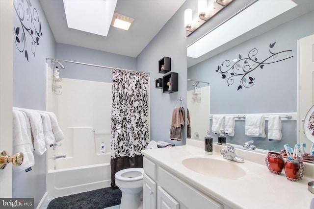 full bathroom with toilet, vanity, a skylight, and shower / bath combo with shower curtain