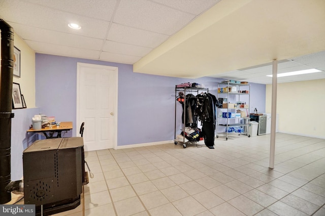 workout room with light tile patterned floors and a drop ceiling