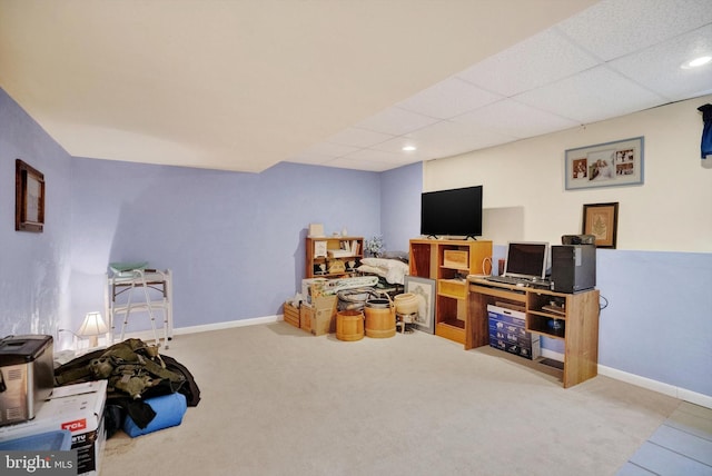 rec room with carpet floors and a paneled ceiling