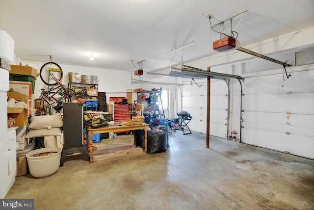 garage with a workshop area and a garage door opener