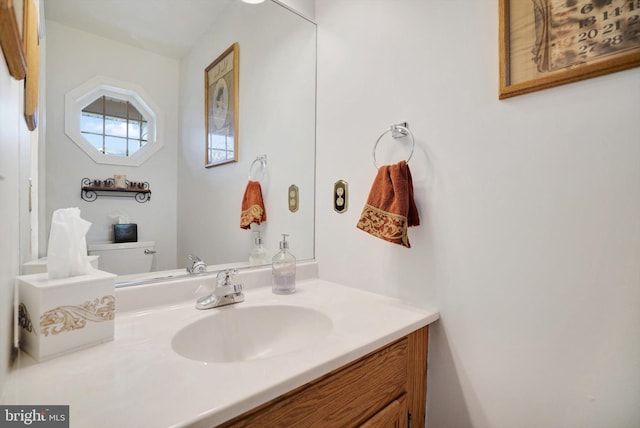 bathroom with toilet and vanity