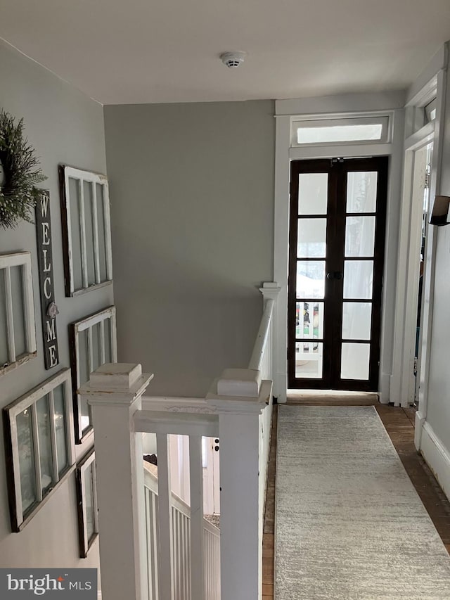 foyer with dark hardwood / wood-style floors and french doors