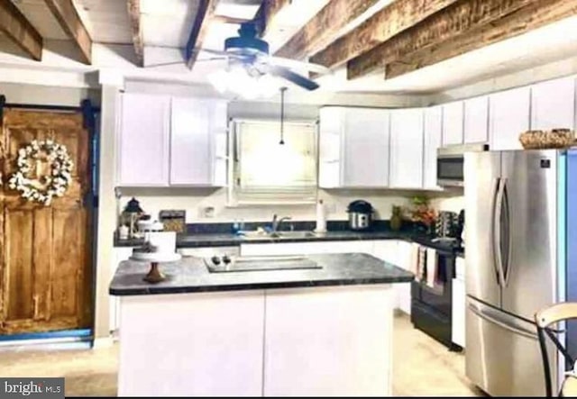 kitchen featuring black appliances, white cabinetry, and a center island