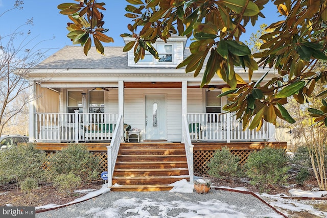 view of front of house featuring roof with shingles, ceiling fan, and a porch