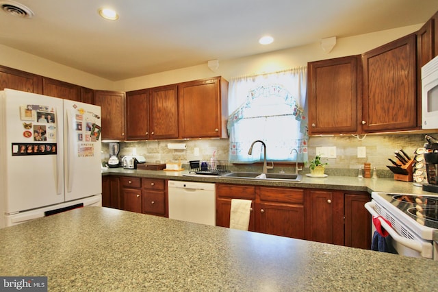 kitchen with white appliances, sink, and tasteful backsplash