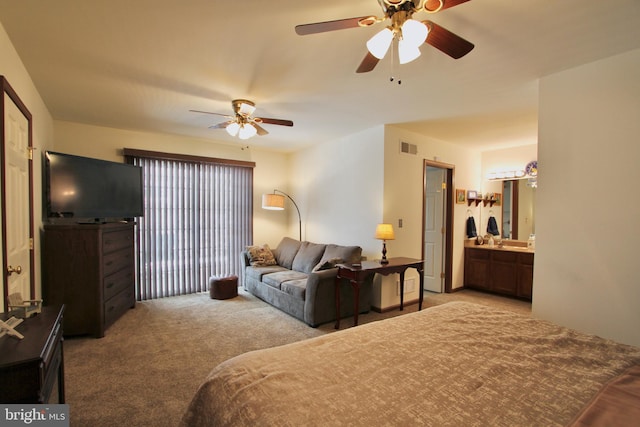 carpeted bedroom featuring connected bathroom and ceiling fan