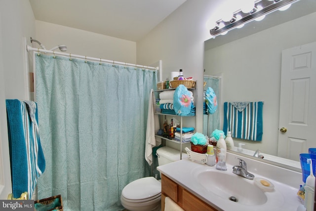 bathroom featuring vanity, toilet, and curtained shower