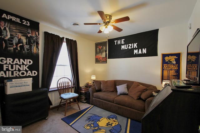 living room with ceiling fan and carpet floors