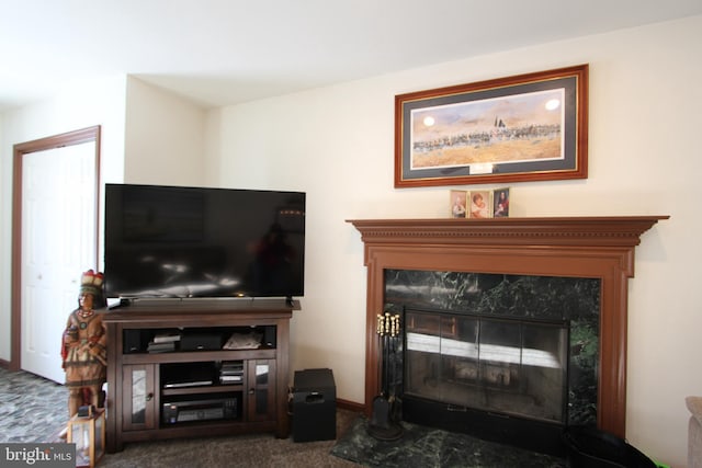 living room with carpet flooring and a high end fireplace