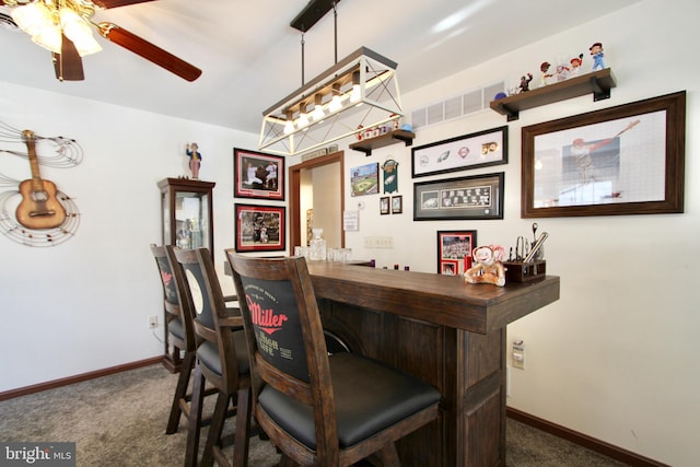 bar with ceiling fan, pendant lighting, and dark colored carpet