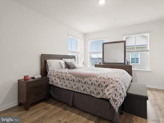 bedroom featuring light wood-type flooring and baseboards