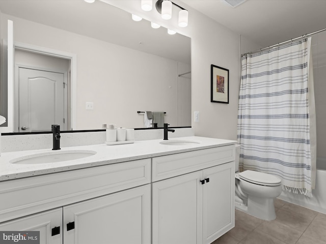 bathroom with double vanity, toilet, shower / tub combo with curtain, and a sink