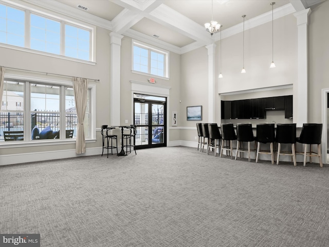 carpeted living room featuring visible vents, crown molding, baseboards, beamed ceiling, and coffered ceiling