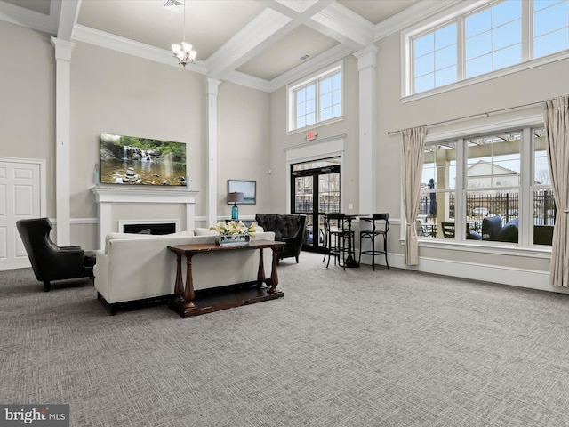 living area featuring decorative columns, beam ceiling, carpet flooring, a fireplace, and coffered ceiling