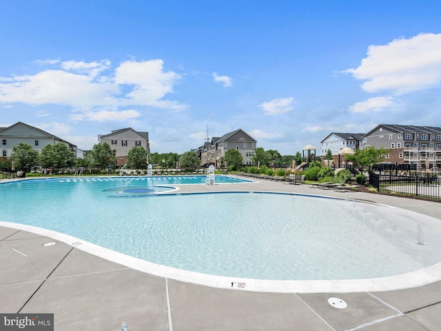 pool with a residential view and fence