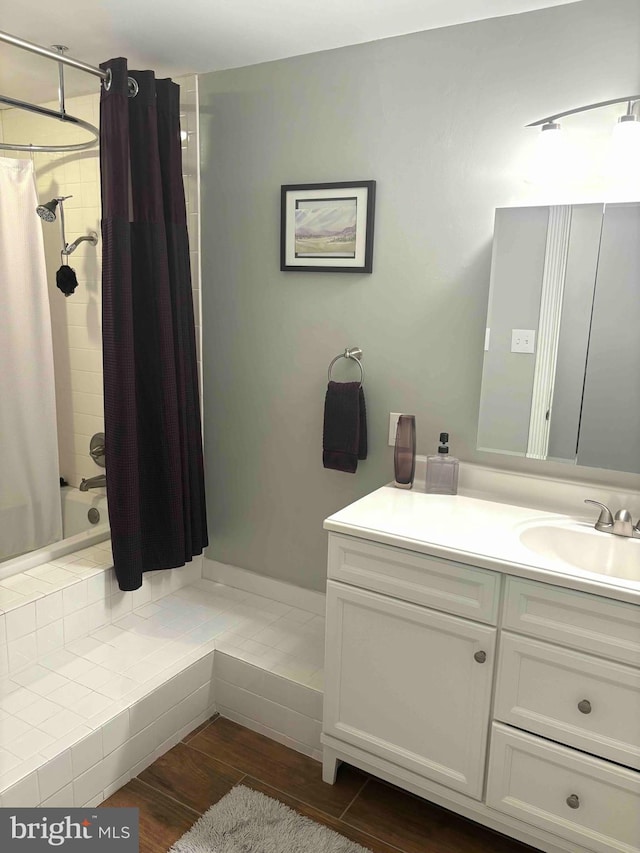 bathroom featuring hardwood / wood-style floors, shower / tub combo with curtain, and vanity