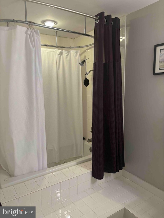 bathroom featuring tile patterned flooring and shower / bathtub combination with curtain