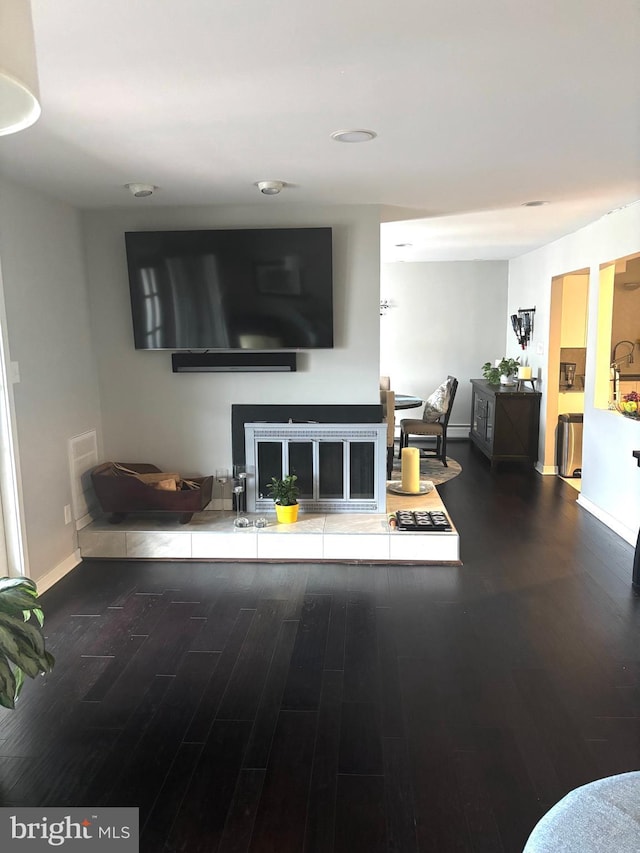 living room with dark hardwood / wood-style floors