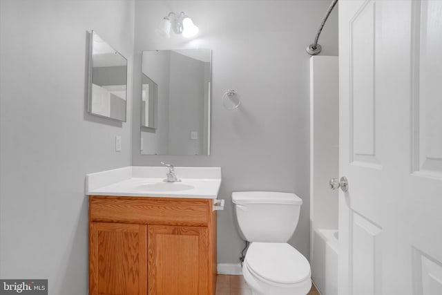 full bathroom featuring tile patterned floors, bathing tub / shower combination, vanity, and toilet