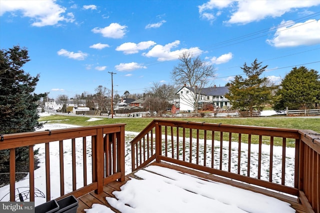 snow covered deck with a lawn