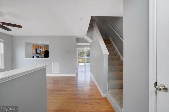 corridor with light hardwood / wood-style flooring