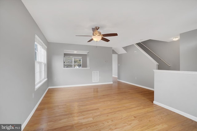 unfurnished living room with ceiling fan and light hardwood / wood-style flooring