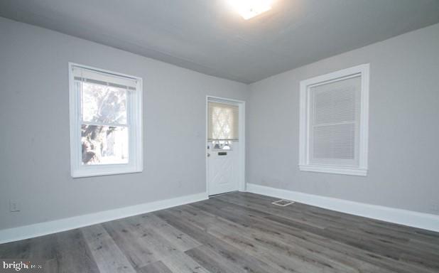 empty room featuring dark hardwood / wood-style flooring