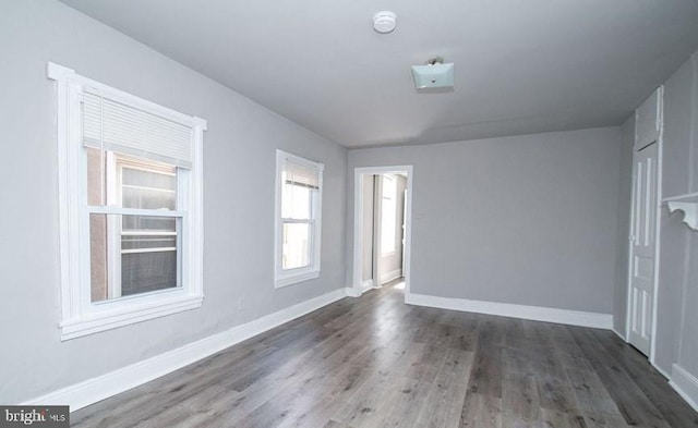 unfurnished room featuring dark hardwood / wood-style flooring