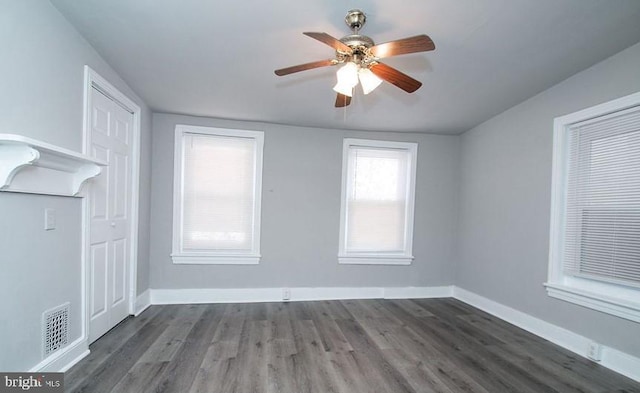 unfurnished room with dark hardwood / wood-style floors and ceiling fan