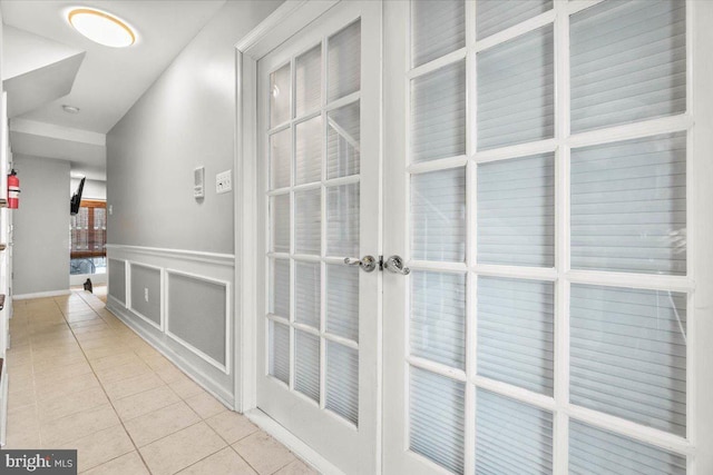 hall featuring light tile patterned flooring