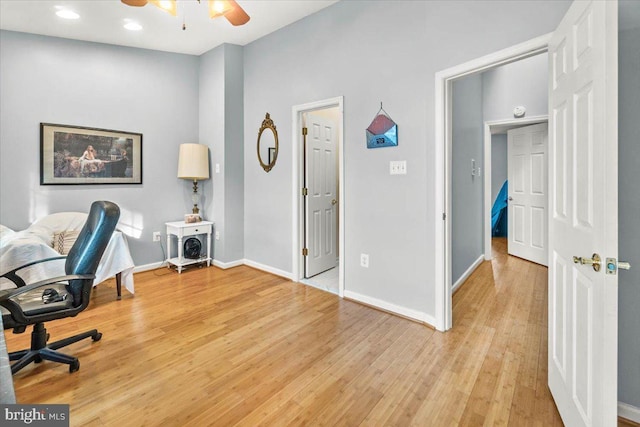 home office featuring light wood-type flooring and ceiling fan