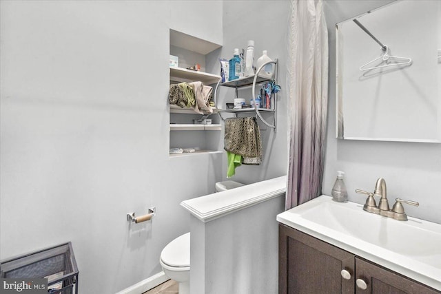 bathroom with toilet and vanity