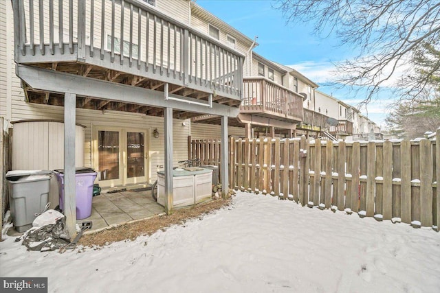 snow covered property with a patio area