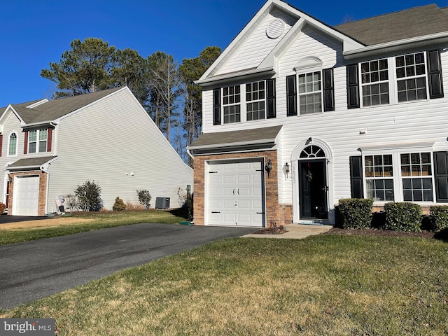 view of front of house featuring central AC, a garage, and a front lawn