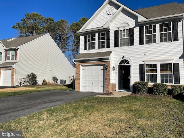 view of front of property featuring a garage, central AC unit, and a front lawn