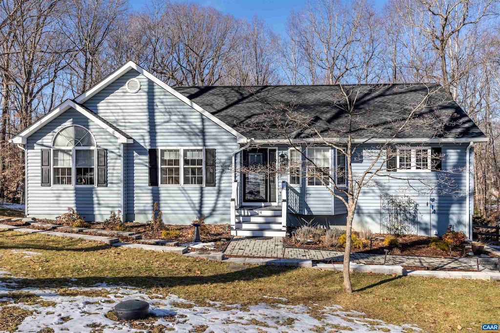 ranch-style home with a yard