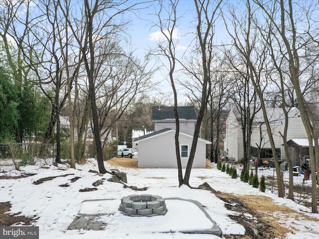 snowy yard featuring a fire pit