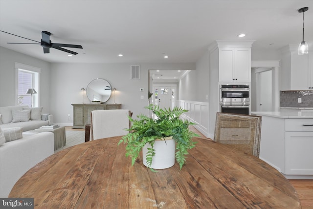 dining area featuring light wood-type flooring and ceiling fan