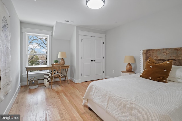 bedroom with light wood-type flooring and a closet