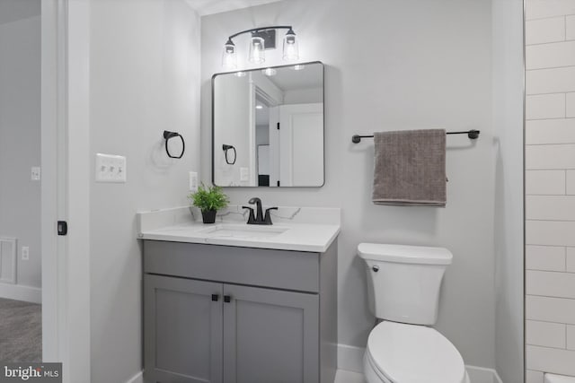 bathroom with toilet and vanity