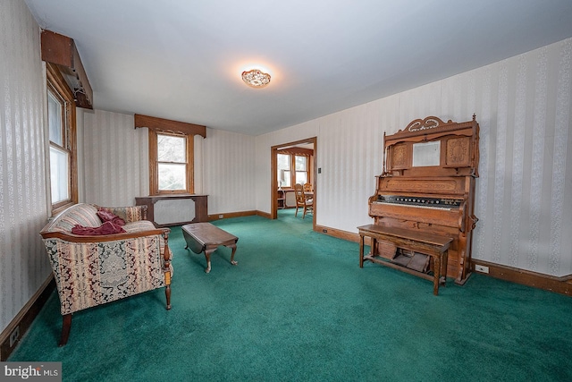 sitting room featuring dark carpet