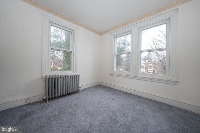 unfurnished room featuring radiator and carpet floors