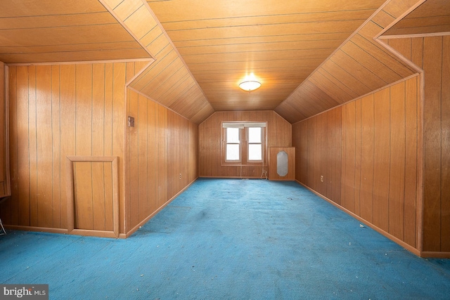 bonus room featuring wooden ceiling, vaulted ceiling, wood walls, and carpet flooring