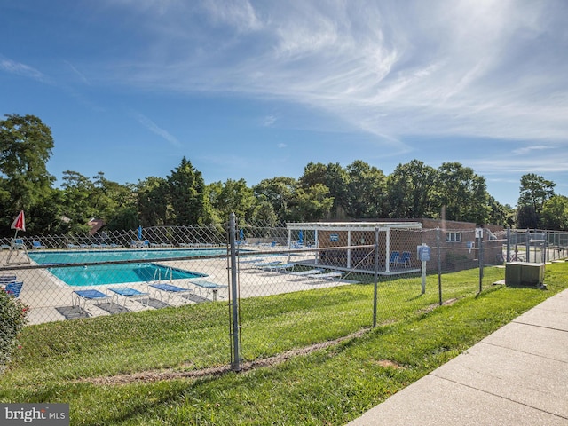 view of swimming pool with a lawn and a patio