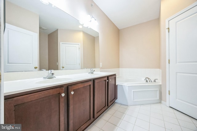 bathroom featuring tile patterned floors, a bathing tub, and vanity